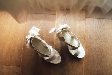 Top view of pair of white wedding shoes on wooden floor background. Wedding day Stock Photos