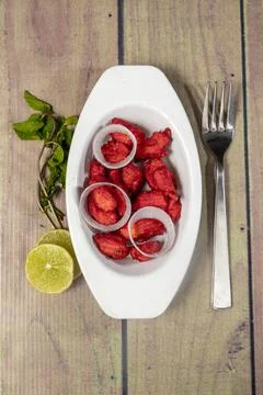 Top view of paneer 65 with ring onions lemon and coriander Stock Photos