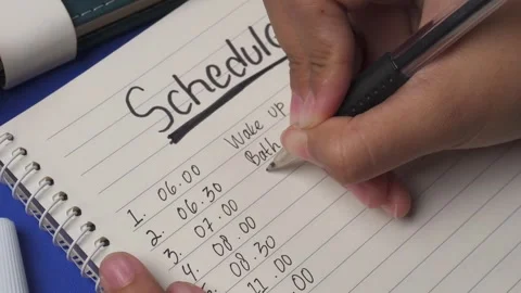 Top view panning shot of write a daily activity schedule in a book Stock Footage 276826573