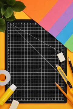 Top view of the paper crafts work table. Craft knife, pencil, eraser, cutti.. Stock Photos