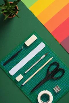 Top view of the paper crafts work table. Stationery supplies and colorful pap Stock Photos
