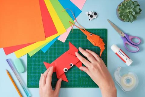 Top view of paper cutting tools, scissors, cutter and paper crafts. Women's.. Stock Photos