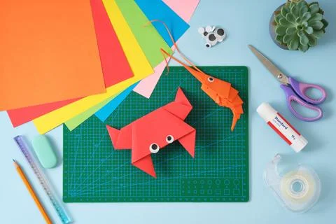 Top view of paper cutting tools, scissors, cutter, and crab and shrimp pape.. Stock Photos