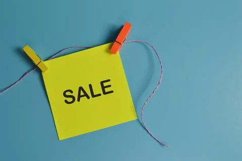 Top view of paper note written with SALE isolated on blue background Stock Photos