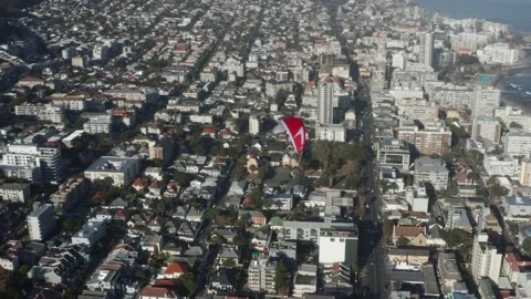 Top view of paraglider flying over city with parachute. Adrenaline and Stock Footage 201528232