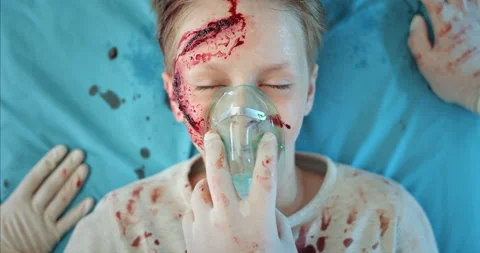 Top view of paramedics hands taking off oxygen inhalation mask from little kid Stock Footage 139691707
