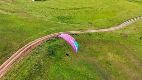 Top view of the parasailing flight above the fields Stock Footage 113515566