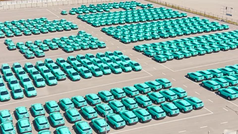 Top view of a parking lot with new turquoise electric crossover taxis Stock Footage 340580655