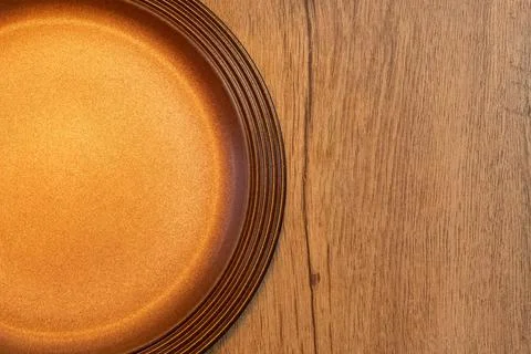 Top view part of empty brown plate on rustic wooden table copy space for text Stock Photos