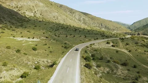 Top view of a passenger car that is driving on a mountain road in Turkey Stock Footage 194837036