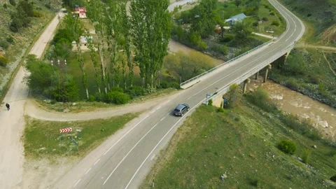 Top view of a passenger car that is driving on a mountain road Stock Footage 194837122