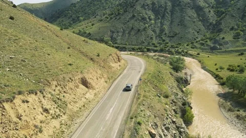 Top view of a passenger car that is driving on a mountain road Stock Footage 194837264