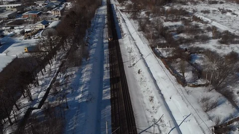 Top view of passenger train with carriages on railways at winter. Aerial shot Stock Footage 104246255