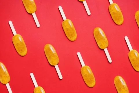 Top view passion fruit popsicle or ice lolly or ice pops flat lay pattern on red Stock Photos