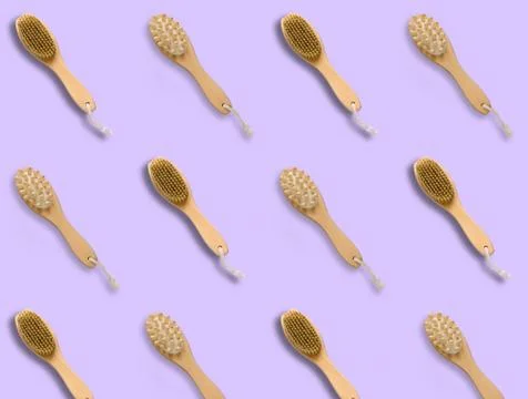 Top view pattern brush for dry skin massage on a pastel violet background,cop Stock Photos