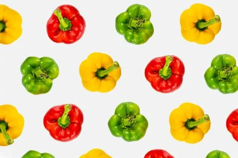 Top view pattern of fresh bright bell peppers on white background Stock Photos