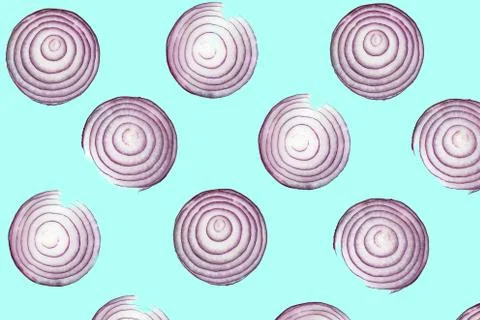 Top view pattern of fresh bright red onion rings on turquoise blue background Stock Photos