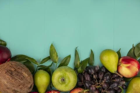 Top view of pattern of fruits as coconut pear peach grape apple with leaves.. Stock Photos