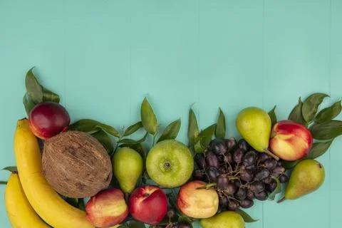 Top view of pattern of fruits as coconut pear peach grape apple banana with.. Stock Photos