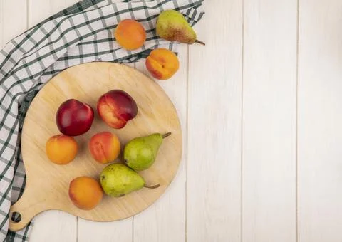 Top view of pattern of fruits as peach apricot and pear on cutting board an.. Stock Photos