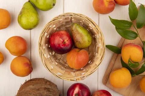 Top view of pattern of fruits as peach pear apricot in basket and peaches o.. 스톡 사진