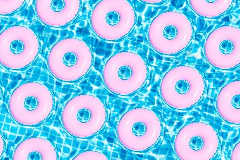 Top view of pattern of pink floats on swim pool. Summer concept. 3d illustrat Stock Photos