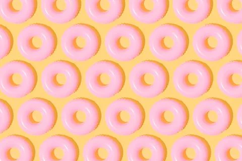 Top view of pattern of pink floats on a yellow background. Summer concept. 3d Stock Photos
