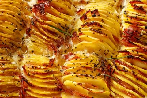 Top view, pattern with Potato gratin, backed potato slices with bacon, ham,.. Stock Photos