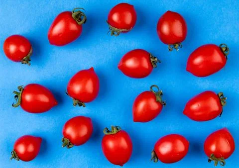 Top view of pattern of tomatoes on blue background 写真素材