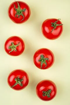 Top view of pattern of tomatoes on yellow background Stock Photos