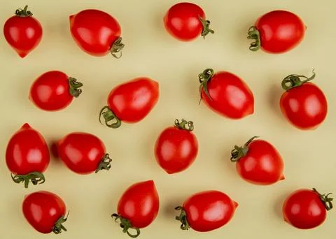 Top view of pattern of tomatoes on yellow background Stock Photos