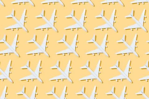 Top view of pattern of white airplanes on a yellow background. Travel and sum Stock Photos