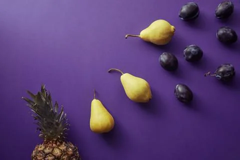 Top view pears plums pineapple Stock Photos