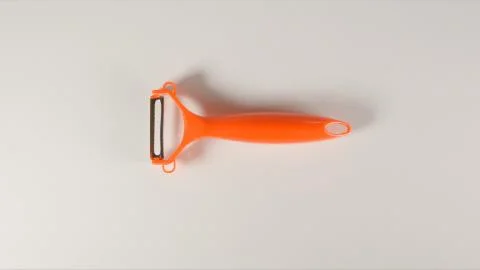 TOP VIEW: Peeler on a white table Stock Photos