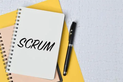Top view of pen and notebook written with SCRUM. Conceptual image 스톡 사진