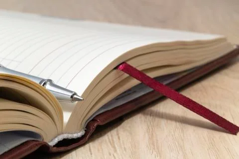 Top view - pen on an opened notebook close up. Stock Photos