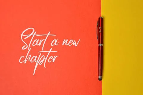 Top view of pen with text START A NEW CHAPTER Stock Photos