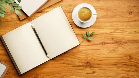 Top view of a pencil between blank pages in open notebook with coffee cup o.. Stock Illustration