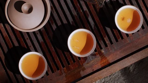 Top view of people hands taking teacups full of hot tea close up  Stock Footage 116628324
