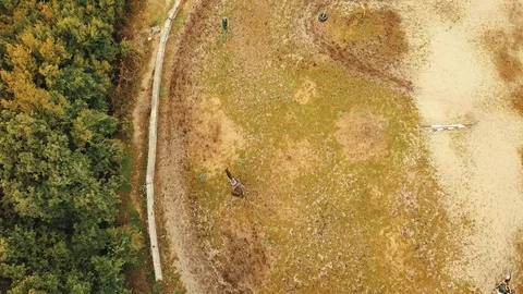 Top view of people learning how to ride horse on the mountain field on a summ Stock Footage 93008953