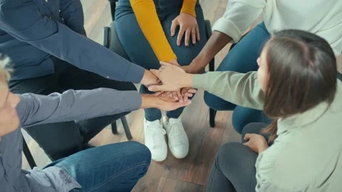 Top View. People Sitting in a Circle Holding Hands in a Group Therapy Session. Stock Footage 166845382
