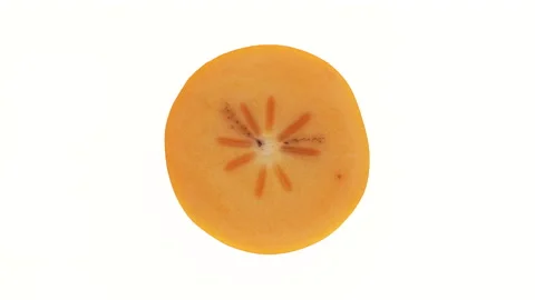 Top view of a persimmon fruit cross-section cut. Rotating on white background. Stock Footage 166225207