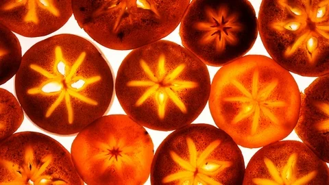 Top view of persimmon fruit slices in flat lay close up, rotating clockwise Stock Footage 86430644