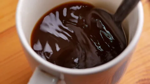 Top view of person hand stirring black coffee with spoon. Video stock 157086225