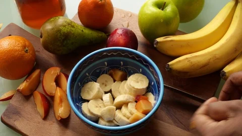 Top view person making healthy fruit salad at home - 8 s Stock Footage 128716933