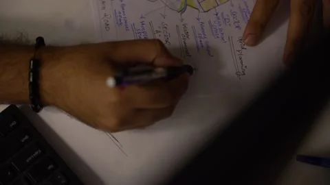 Top view a person sitting at the table at midnight, making notes or planning Stock Footage 236811854