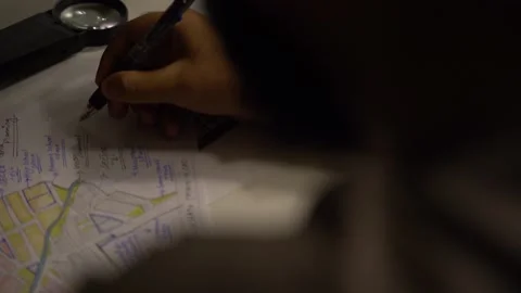 Top view a person sitting at the table at midnight, making notes or planning Stock Footage 236811856