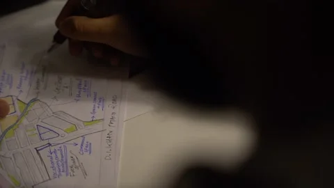 Top view a person sitting at the table at midnight, making notes or planning Stock Footage 236811860