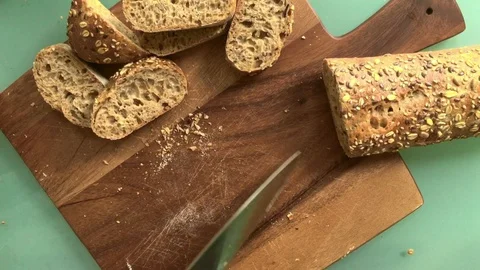 Top view person slicing bread on wooden board -8s 스톡 동영상 127870098