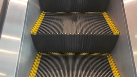 Top view of a person walking up an escalator Stock-Footage 312096743